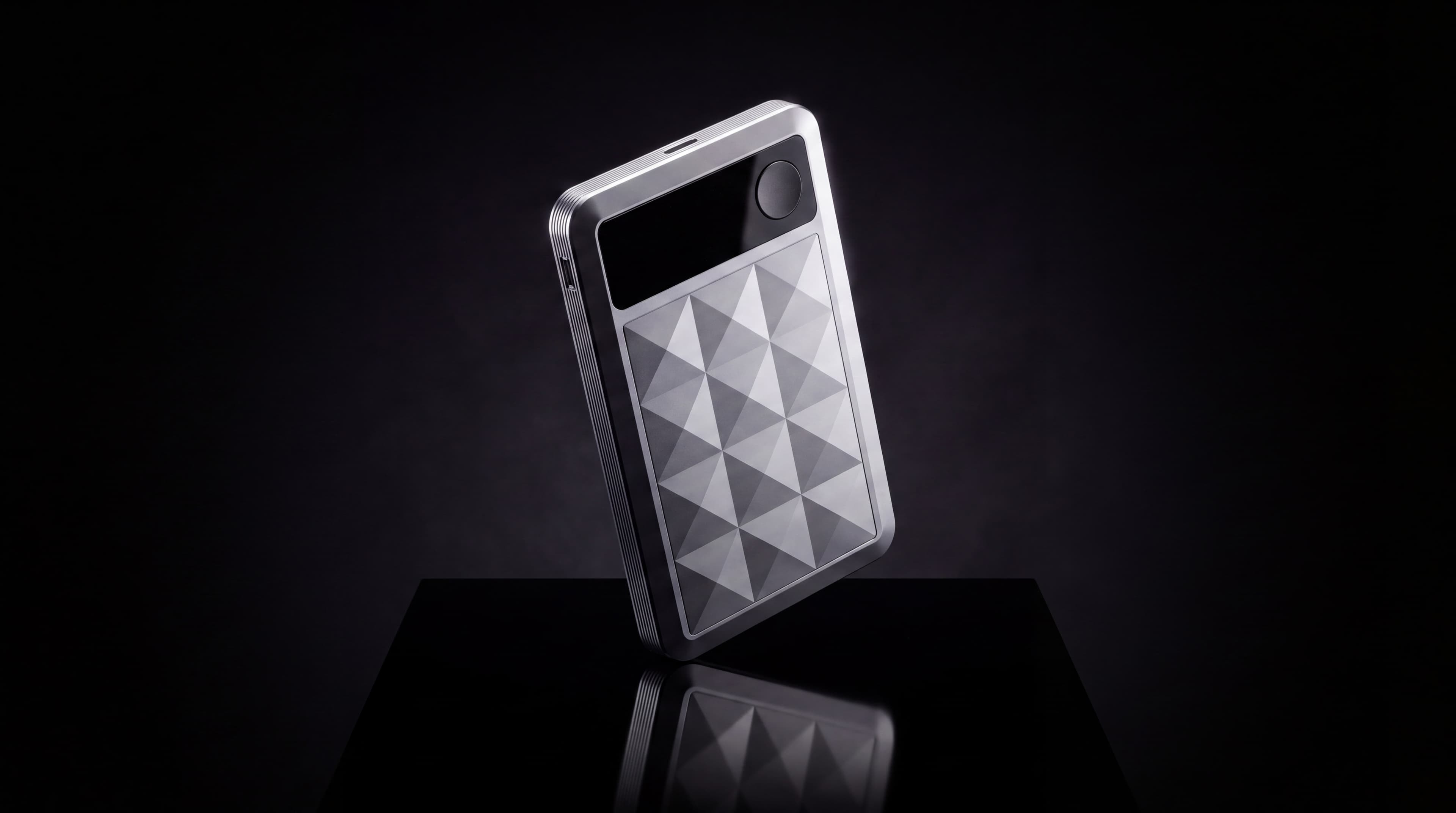 chit one Pro standing at a three-quarter angle in darkness, its faceted face catching a single light.